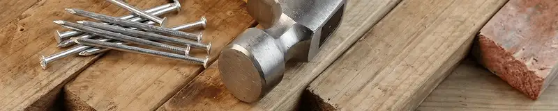 Hammer and nails on hardwood flooring boards in Spokane, WA