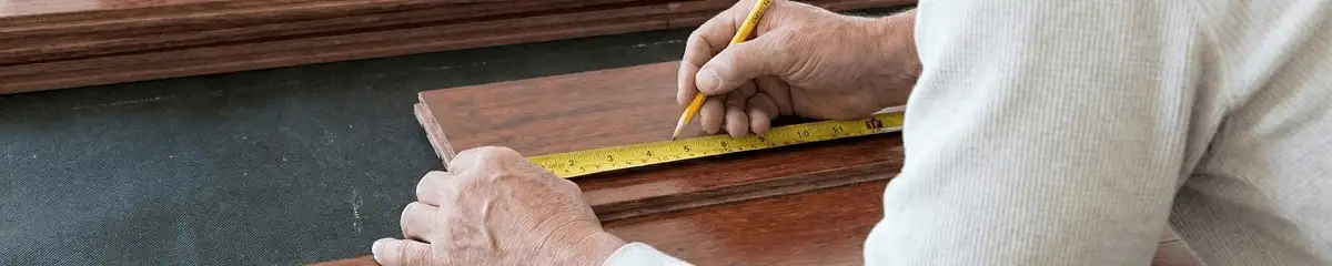 A professional installing wood flooring in Spokane, WA